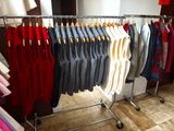 a lot of clothes hanging on a rack in a room