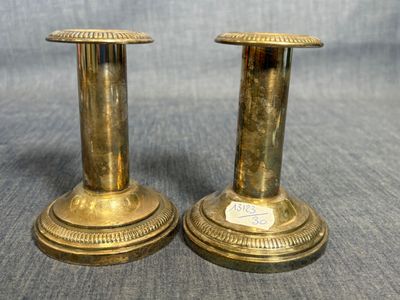 paire de chandeliers anciens en laiton sur fond gris