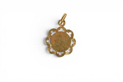 a gold plated pendant with a flower design on it