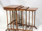 three wooden nesting tables with turned legs on a white background
