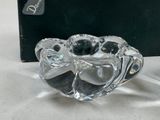 a glass candle holder that is sitting on a table