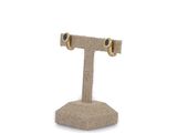 pair of gold and black diamond stud earrings on a stand