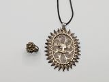 an image of a necklace and earring on a white surface