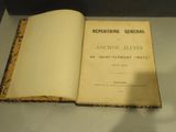 an open book sitting on top of a table next to a glass case