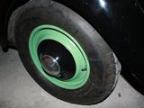 a black car with a green rim parked in a garage