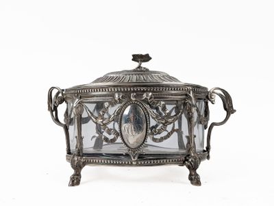 an antique silver plated box with a glass cover on a white background