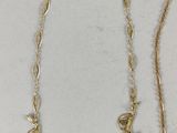 a close up of two necklaces on a white surface