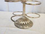 a silver candle holder on a table with a number on it