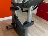 an image of a stationary exercise bike in a room with a red wall
