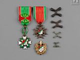 a group of medals including a cross, medal, and other items
