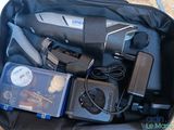 a bag filled with electronics and other items in it