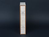 a book with a wooden cover sitting on top of a black surface
