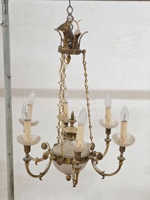 a chandelier that has five lights hanging from it
