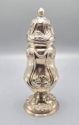 a silver vase with a lid sitting on top of a table