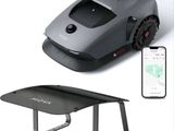 an image of a robotic lawn mower next to a phone
