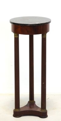 une image représentant une table ronde avec un piètement en bois et un plateau en marbre