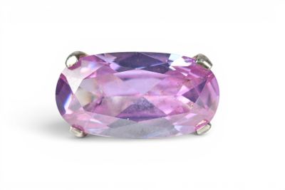 a close up of a ring with a pink stone on a white background