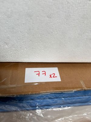 a box with a sign on it sitting on the floor