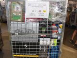a metal cart with many items in it in a warehouse