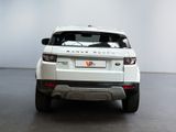 a white range rover parked in a white room