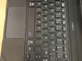a close up of a laptop keyboard on a wooden table