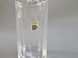 an image of a clear glass bottle sitting on a white surface