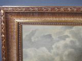 an image of a picture of a painting of clouds in a gold frame