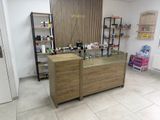 a counter with a glass top and a shelf with bottles on it