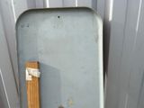 a toilet with a wooden seat in the corner of the room