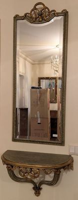 a mirror on the wall above a table and a mirror on the wall