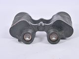 an image of a pair of binoculars sitting on top of a white surface