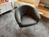 a chair that is sitting in a room with a book shelf