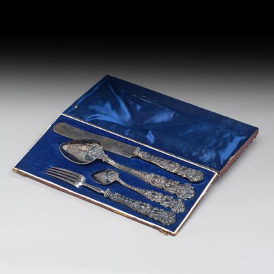 des couverts dans une boîte bleue, comprenant une cuillère, une fourchette et un couteau