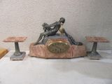 une statue d'un homme assis au sommet d'une horloge