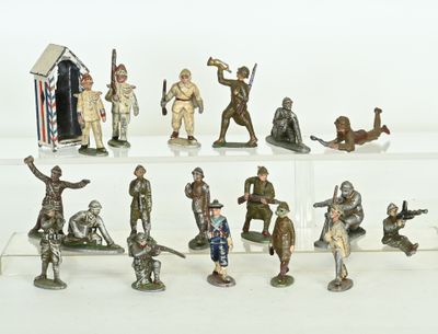many figurines of soldiers on display on a white surface