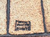 a close up of a piece of wood that has a brick pattern on it