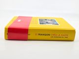yellow and red book sitting on a white surface with a white background