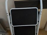 an image of a step stool next to a radiator