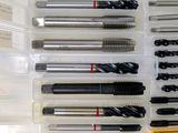 many different types of drill bits in a plastic box