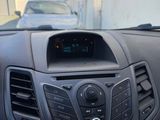 the dashboard of a car with a car in the background and a car in the foreground