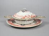 a white and red bowl and saucer on a saucer