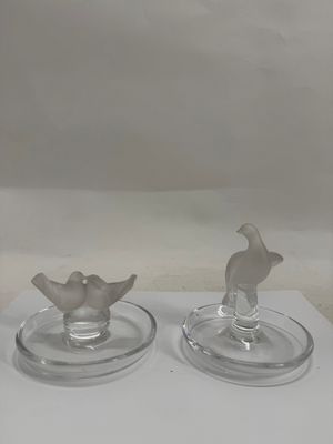 two glass candlesticks sitting on a white table