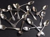 a lot of spoons arranged in a circle on a table