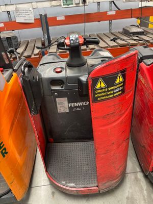 many different types of forklifts in a warehouse