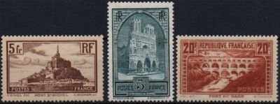 four different postage stamps with a picture of a church in the background