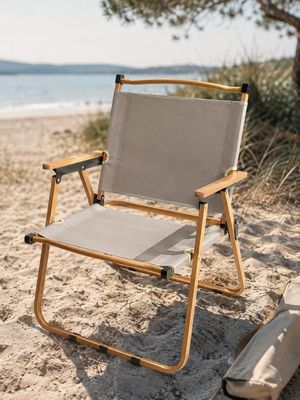 a chair that is sitting on the sand by the water