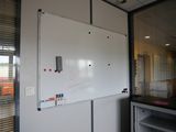 a white board on the wall in a room