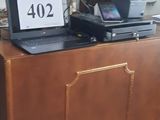a laptop sitting on top of a desk in a room