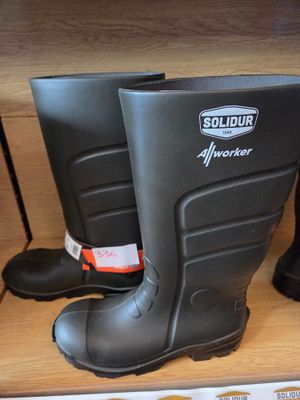 a pair of black rubber boots on display in a store