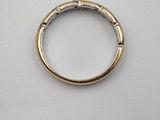 a close up of a gold ring on a white surface